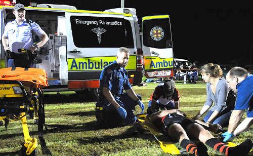 Paramedics tend to injured player Chris Hughes at Saturday nights Aussie rules season opener. Paramedics tend to injured player Chris Hughes at Saturday nights Aussie rules season opener.